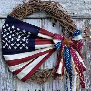 Detail of USA Independence Day rustic wreath with flag bow and star on a wooden wall