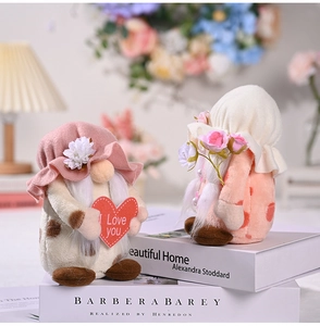 Close-up of mother's day faceless gnomes holding I Love You heart and pink roses