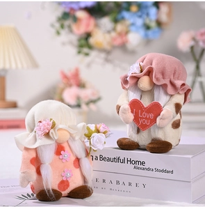 Close-up of plush Mother's Day gnomes holding a red heart and rose flower bouquet