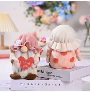 Close-up of plush Mother's Day gnomes holding a heart and flowers for home decor