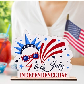 Close-up of wood 4th of July tabletop decoration featuring Liberty crown and fireworks