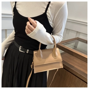 Beige vintage minimalist crossbody bag with top handle and sleek leather finish