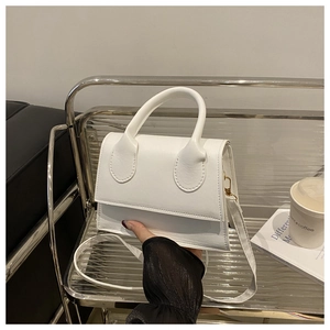 Detailed view of the white minimalist small square crossbody bag with top handle