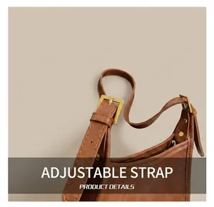 Detailed close-up of adjustable brown leather shoulder strap with gold buckle and rivets