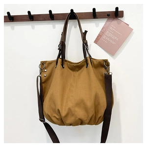 Japanese retro large canvas hobo bag in brown with adjustable strap on a wall hook