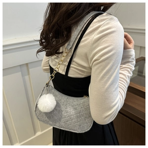 Detail of light gray felt shoulder bag with diamond stitching and gold chain