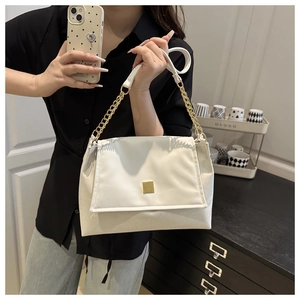 Detail of white leather shoulder bag with gold square buckle and chunky chain strap