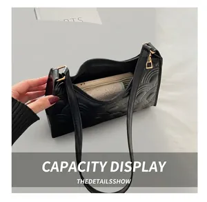 Interior view of black crescent bag showing capacity for phone and essentials