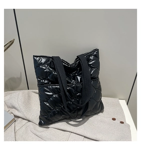 Close-up of black quilted tote bag featuring glossy nylon fabric and rhombic stitching
