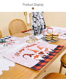 Detailed Christmas table mat showing three gnomes with a red and black plaid border