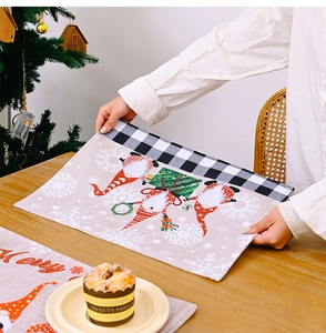 Close-up of Christmas gnome placemat with heat-resistant fabric and festive red hat motifs