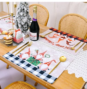 Close-up of heat-resistant Christmas gnomes placemat with Merry Christmas text on wood table