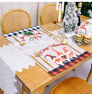 Close-up of Christmas gnome place mats with red buffalo plaid on a festive dining table