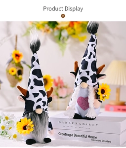 Detail of cow-themed bee festival gnomes with sunflower accents on decorative books