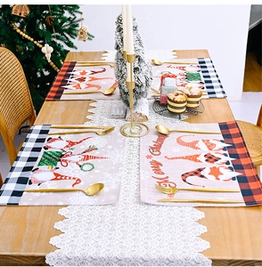 Close-up of buffalo plaid Christmas placemats with cute gnomes on a festive wooden table