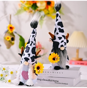 Detailed view of handmade cow-themed gnomes with sunflowers and horns for home decor