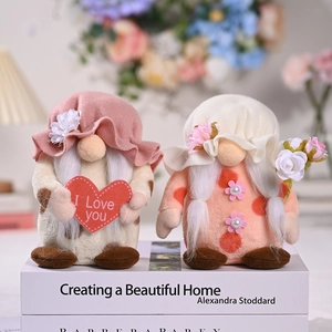 Handmade plush Mother's Day gnomes set with heart and flower on decorative books