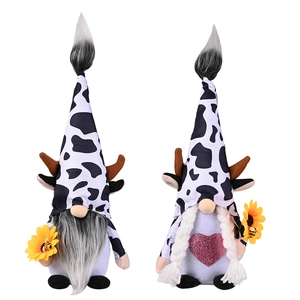 Pair of plush cow themed gnomes with sunflower and bee accents for home decoration