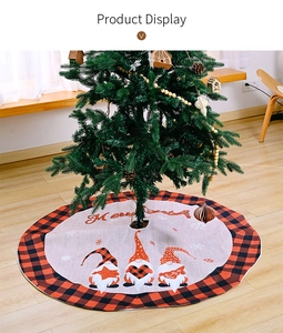 Detail of a Christmas tree skirt featuring buffalo plaid gnomes and Merry Christmas text