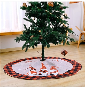 Detail of Christmas tree skirt with red buffalo plaid edge and Nordic gnome patterns