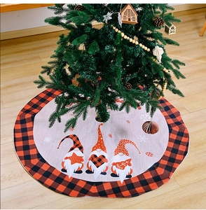 Detail of Christmas tree skirt with gnome prints and red black buffalo plaid border