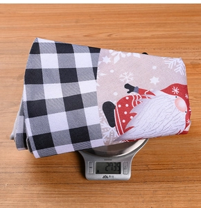 Close-up of a 273.9g Christmas tree skirt with plaid pattern and Santa Claus design