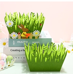 Detailed macro view of green felt Easter baskets with rabbit and daisy appliques