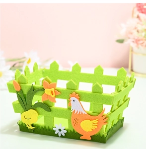 Detail of Easter felt storage basket with green fence design and cartoon chicken motifs