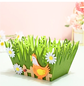 Detail of green felt Easter basket featuring white daisies, a wooden fence, and a rooster
