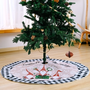 Christmas tree skirt with buffalo plaid edges and festive gnome prints on wooden floor