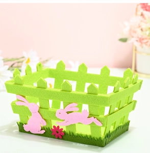 Detail of Easter felt basket with green fence design, pink bunny, and flower decorations