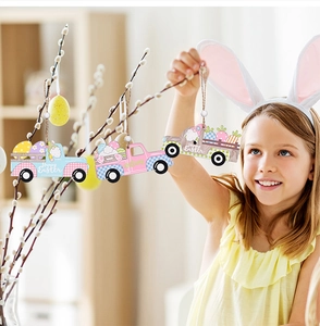 Smiling girl holding Easter wooden truck hanging ornaments with festive beads and colorful eggs