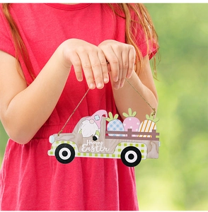 Detail of wooden Easter gnome car pendant held by child, Happy Easter hanging decoration