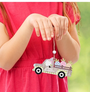 Detail of wooden Easter truck ornament with Happy Easter text and gnome held by a child