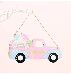 Pink wooden Easter truck ornament with welcome text hanging on a white branch