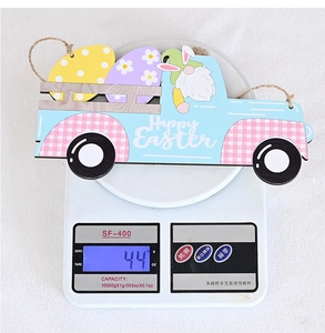 Detail of blue Easter wooden car ornament showing weight of 44g on a white scale