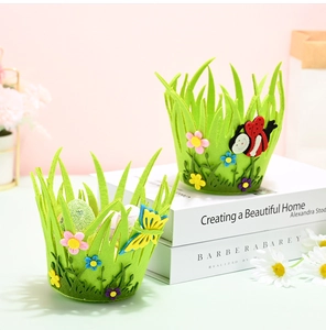 Detail of green Easter felt baskets with decorative floral, ladybug and butterfly patches