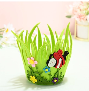 Detail of green felt Easter basket featuring colorful flowers and a 3D ladybug decoration