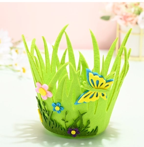Detail of green felt Easter basket with yellow butterfly and colorful flower ornaments