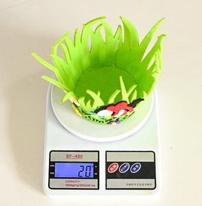 Weight measurement of a green felt Easter basket showing 20g on a digital scale