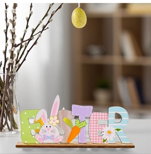 Detail of colorful wooden Easter letter plaque with bunny and daisy patterns on base