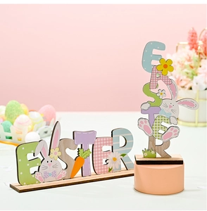 Macro detail of Easter wooden letter decor with rabbit, carrot and daisy floral patterns