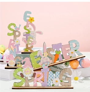 Close-up of Easter wooden letter ornaments with gnomes, rabbits and spring flower motifs