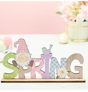 Detail of wooden SPRING letter sign with gnome, bird, and daisy floral decorations