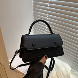 Classic black leather crossbody bag with checkered pattern and round decorative buttons