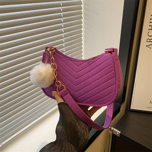 Purple underarm bag with V-shaped quilting, gold chain and white pompom charm