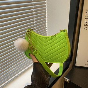 Neon green quilted underarm bag with plush charm and metal chain strap for women