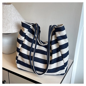 Close-up of thick canvas weave and blue stripes on this large capacity tote bag