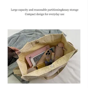 Internal view of a corduroy tote showing large capacity storage for tablet and umbrella
