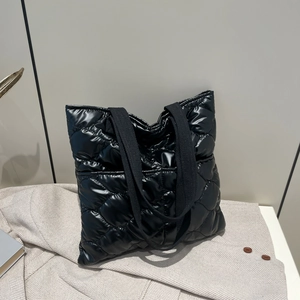 Glossy black quilted tote bag with diamond texture and wide shoulder straps for women